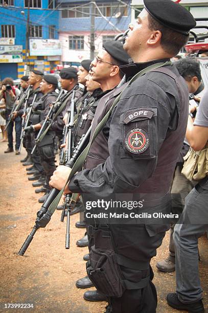 Military occupation of Rocinha for installation of Pacifying Police Unit . Tropa prepares to sing the Hino National in front the flags the Brazil and...