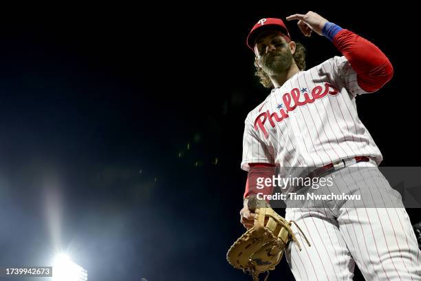 Bryce Harper of the Philadelphia Phillies enters the dugout following a 5-3 victory against the Arizona Diamondbacks in Game One of the Championship...