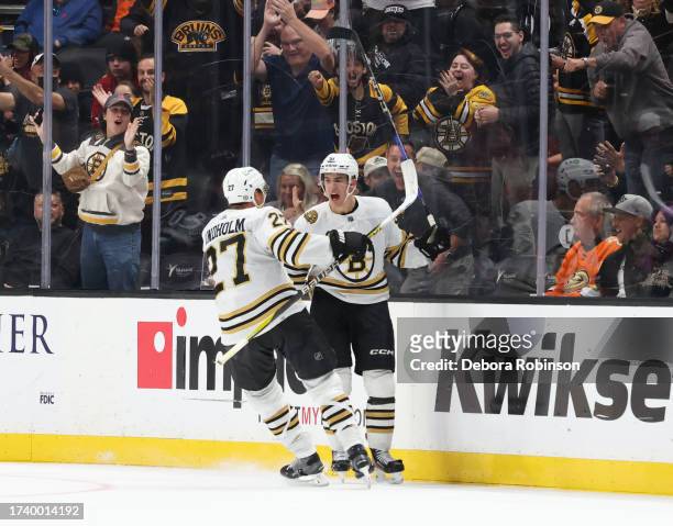 Matthew Poitras of the Boston Bruins celebrates his second goal of the third-period with Hampus Lindholm during the game against the Anaheim Ducks at...