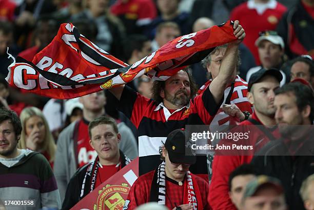 Manchester United fans watch from the stand during a first team training session as part of their pre-season tour of Bangkok, Australia, China, Japan...