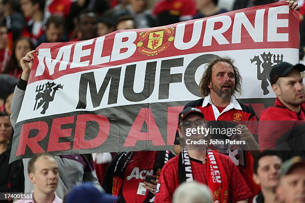 Manchester United fans watch from the stand during a first team training session as part of their pre-season tour of Bangkok, Australia, China, Japan...