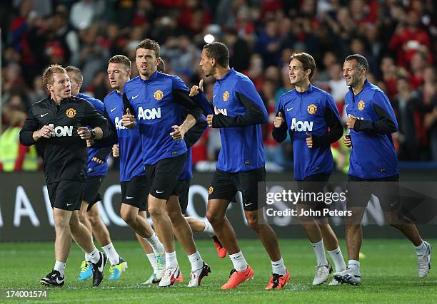 Michael Carrick, Rio Ferdinand, Adnan Januzaj and Ryan Giggs of Manchester United in action during a first team training session as part of their...