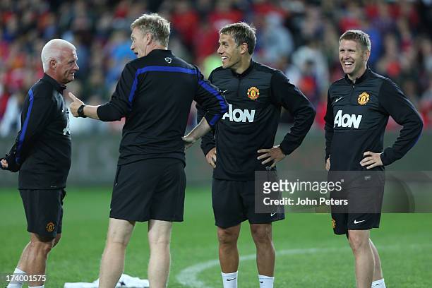Coach Jimmy Lumsden, Manager David Moyes, First Team Coach Phil Neville and Assistant Manager Steve Round of Manchester United in action during a...