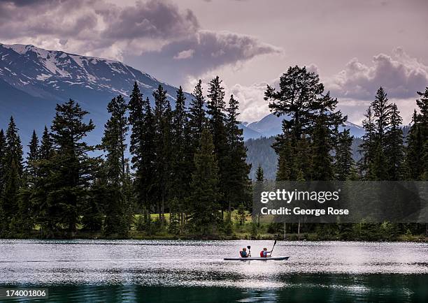 People paddle a canoe on Beauvert Lake at the Fairmont Jasper Park Lodge on June 24, 2013 near Jasper, Alberta, Canada. Jasper is the largest...