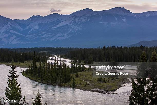 The Athabasca River flows through downtown on June 25, 2013 near Jasper, Alberta, Canada. Jasper is the largest National Park in the Canadian Rockies...