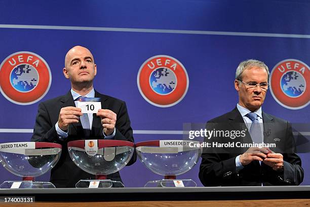 Gianni Infantino, UEFA General Secretary, shows the number 16 as Giorgio Marchetti, UEFA Competition Director, opens a ball during the UEFA Europa...
