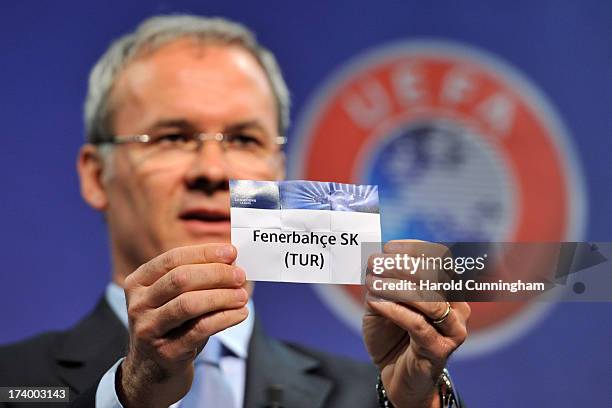 Giorgio Marchetti, UEFA Competition Director, shows the name Fenerbahce SK during the UEFA Champions League Q3 qualifying round draw at the UEFA...