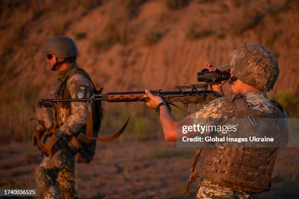 Military volunteers and foreign legionnaires, enlisted to fight in the Armed Forces of Ukraine, practice target shooting on a kaolin quarry on August...