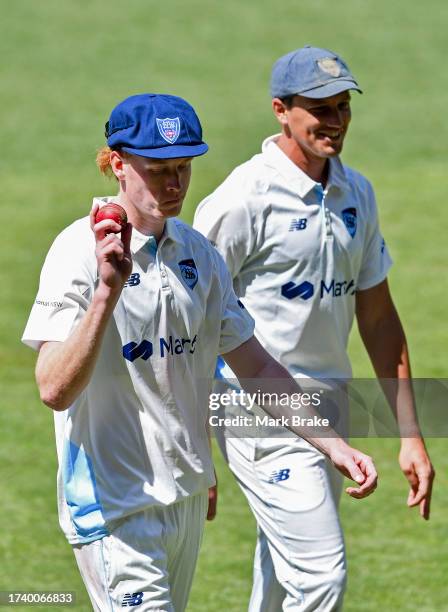 Jack Nisbet of the Blues holds the ball up as he leavesc the ground for his five wickets on debut during the Sheffield Shield match between South...