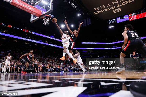 Josh Okogie of the Phoenix Suns drives to the basket ahead of Kris Murray of the Portland Trail Blazers during the second half at Footprint Center on...