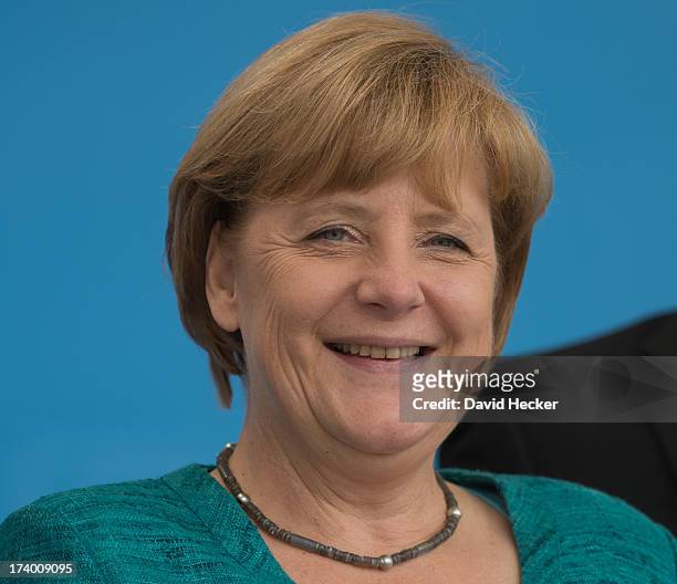 German Chancellor Angela Merkel, who is also chairwoman of the German Christian Democrats , smiles to supporters and passersby during the first leg...
