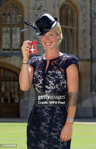 Gold medal winning Olympic Dressage rider Laura Tomlinson after she is made a Member of the Order of the British Empire by Queen Elizabeth II during...