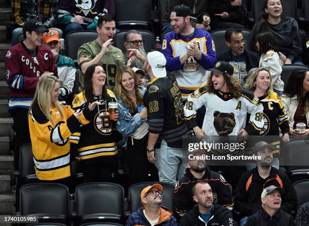 Fans in the stands cheering after the Boston Bruins scored a goal during the third period of an NHL hockey game against the Anaheim Ducks played on...