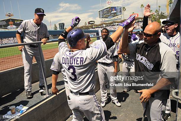 Michael Cuddyer of the Colorado Rockies celebrates with his teammates after hitting a two run homerun against the Los Angeles Dodgers at Dodger...