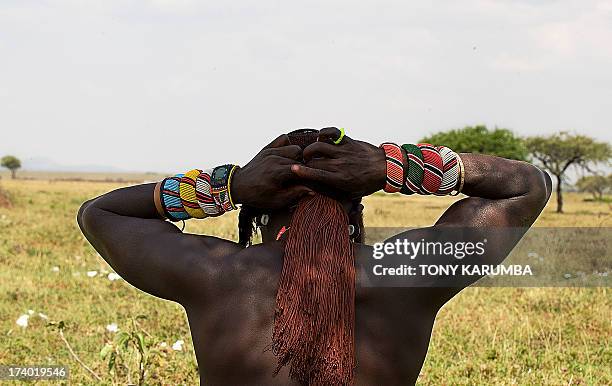 Moran warrior from the Samburu tribe styles his hair on July 16, 2013 in Kisima. Moran, a state attained by young boys upon undergoing a rite of...