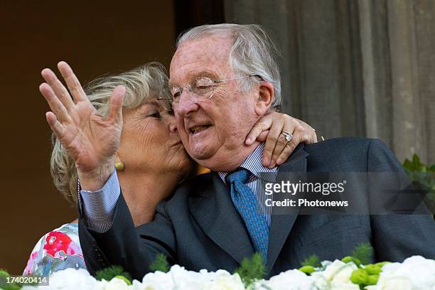 Queen Paola of Belgium kisses King Albert of Belgium during their last official visit as King and Queen of Belgium on July 19, 2013 in Liege, Belgium.