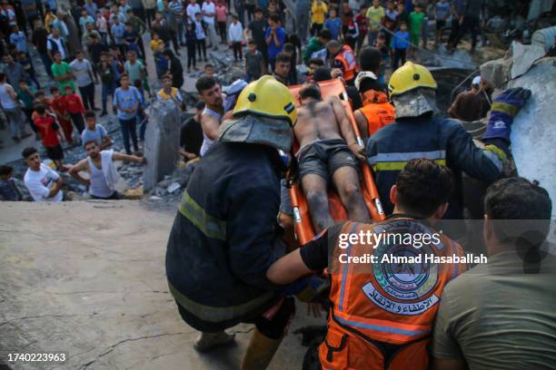 Man is rescued by Palestinian emergency services and local citizens searching for victims in buildings destroyed during Israeli air raids in the...