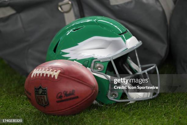 Philadelphia Eagles Kelly green helmet sits on the field next to a football during the game between the Miami Dolphins and the Philadelphia Eagles on...