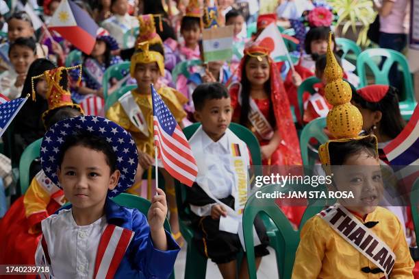 Children are seen wearing costumes to represent different countries during a school activity celebrating United Nations Day ahead of its anniversary...