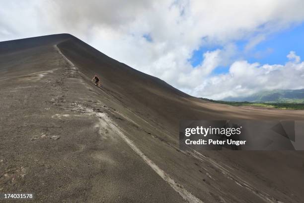 tourist surfing down ash slope of mt yasur vocano - vanuatu stock pictures, royalty-free photos & images