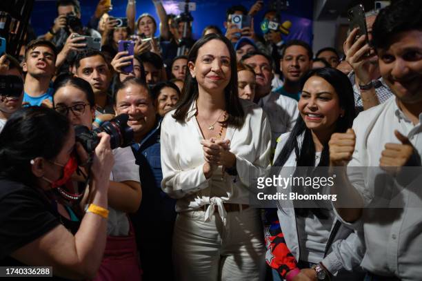 Maria Corina Machado, banned opposition presidential primary candidate for the Vente Venezuela party, center, celebrates during an election night...