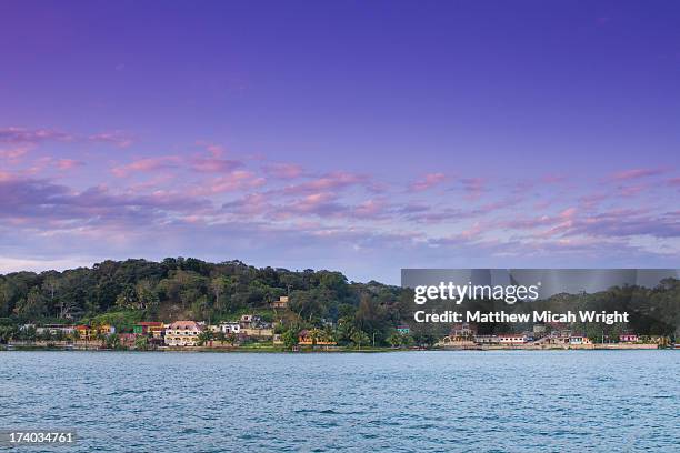 a beautiful sunset along the lake peten river - flores stock-fotos und bilder