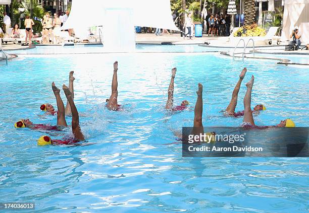 View of synchronized swimming at the Esther Williams cocktail reception during Mercedes-Benz Fashion Week Swim 2014 at The Raleigh on July 19, 2013...