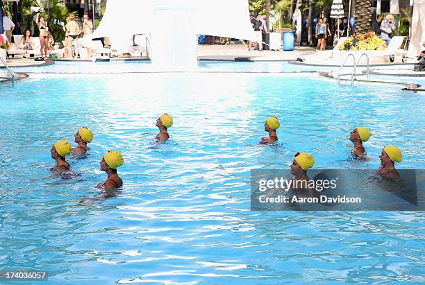 View of synchronized swimming at the Esther Williams cocktail reception during Mercedes-Benz Fashion Week Swim 2014 at The Raleigh on July 19, 2013...