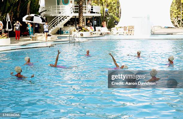 View of synchronized swimming at the Esther Williams cocktail reception during Mercedes-Benz Fashion Week Swim 2014 at The Raleigh on July 19, 2013...