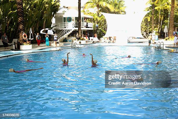 View of synchronized swimming at the Esther Williams cocktail reception during Mercedes-Benz Fashion Week Swim 2014 at The Raleigh on July 19, 2013...