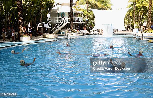 View of synchronized swimming at the Esther Williams cocktail reception during Mercedes-Benz Fashion Week Swim 2014 at The Raleigh on July 19, 2013...