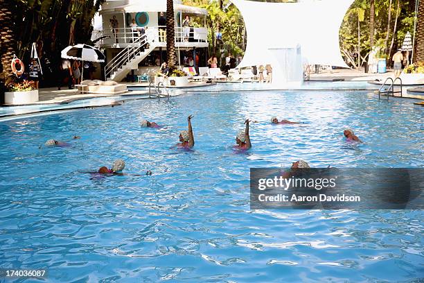 View of synchronized swimming at the Esther Williams cocktail reception during Mercedes-Benz Fashion Week Swim 2014 at The Raleigh on July 19, 2013...