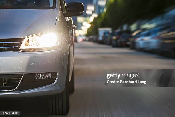 car driving on urban street, low angle view - toyota stock pictures, royalty-free photos & images