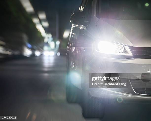 car driving on urban street by night - car light bildbanksfoton och bilder