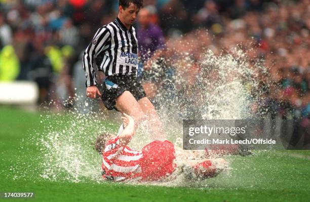 Football League Division One - Newcastle United v Sunderland, Spray flies from the waterlogged pitch as Sunderland defender John Kay slides to tackle...