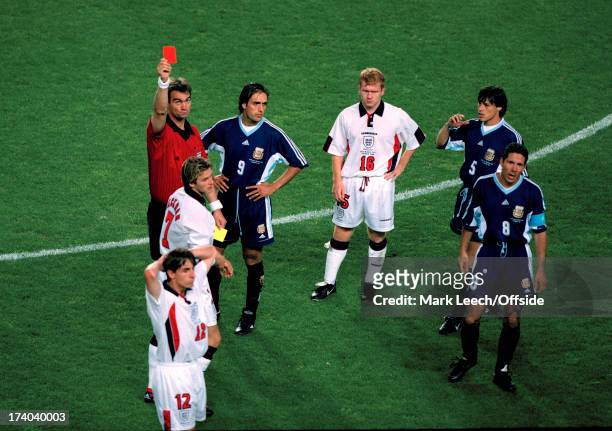 June 1998 Fifa World Cup - England v Argentina - Referee Kim Milton Nielsen shows the red card to David Beckham as Paul Scholes looks accusingly at...