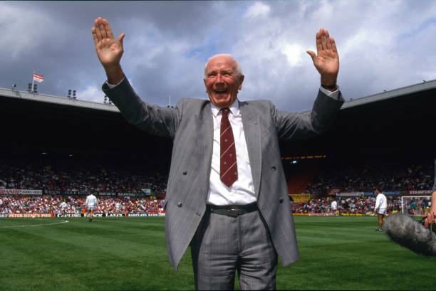 August 1991 - Manchester United FC former manager Sir Matt Busby takes the applause from the Old Trafford crowd at his testimonial match.