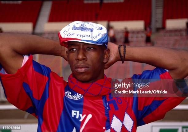 May 1990 - FA Cup Final - Ian Wright wearing a Crystal Palace hat and scarf stands in the empty stadium after the match in which he scored two goals...