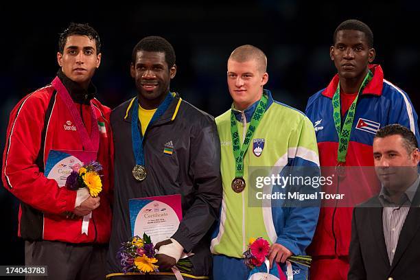 Anthony Obame of Gabon receives the gold medal of men's +87 kg combat of WTF World Taekwondo Championships 2013 at the exhibitions Center on July 19,...