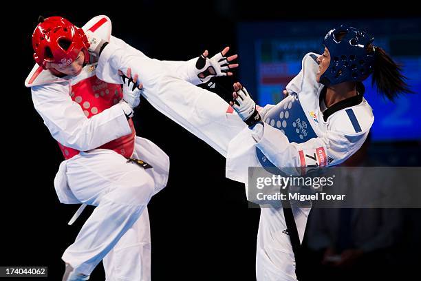 Glenhis Hernandez of Cuba connects the last point to win the gold medal of women's -73 kg final combat against In-Jong Lee of Korea during the WTF...