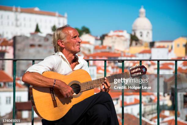 street musician plays guitar and sings fado - fado stock-fotos und bilder