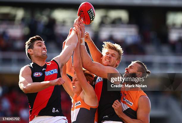 Nick O'Brien and Michael Hurley of the Bombers and Lachie Whitefield and Tim Mohr of the Giants contest possession during the round 17 AFL match...