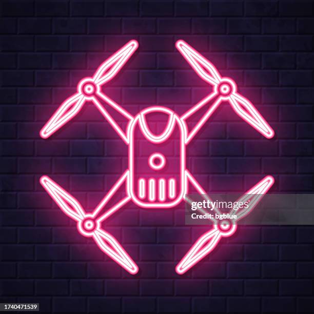 drone - quadcopter. glowing neon icon on brick wall background - camera sensor stock illustrations