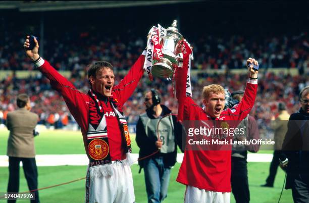 May 1999 FA Cup Final Manchester United v Newcastle United - Manchester goalscorers Teddy Sheringham and Paul Scholes hold the trophy aloft..