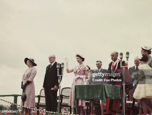 Queen Elizabeth II waving to the crowd at a civic reception and agricultural display at the Claudelands Showgrounds in Hamilton, New Zealand,...
