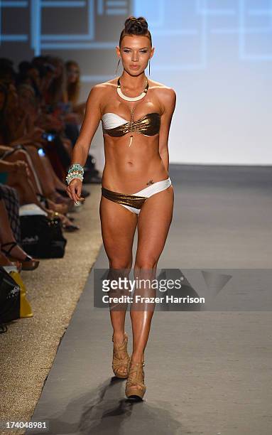 Model walks the runway at the Beach Bunny show with TRESemme during Mercedes-Benz Fashion Week at Cabana Grande at the Raleigh on July 19, 2013 in...
