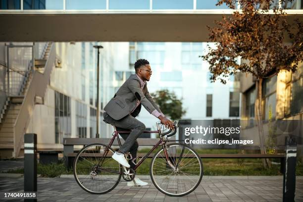 man riding bicycle - man bicycle stock pictures, royalty-free photos & images