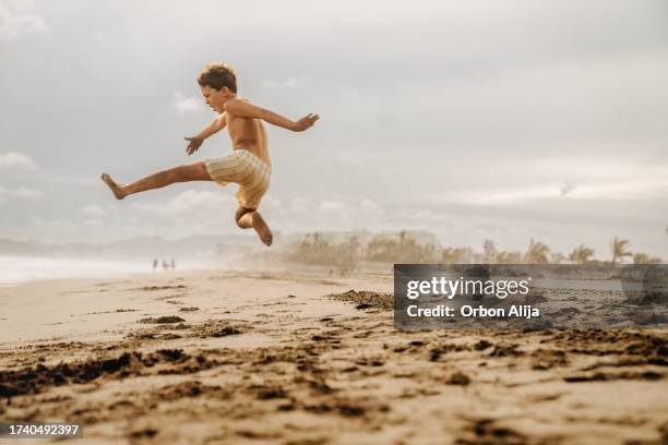 boys jumping at the beach - guerrero stock pictures, royalty-free photos & images