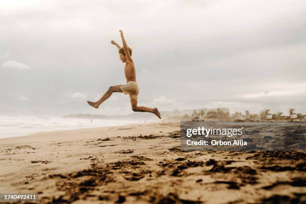 boys jumping at the beach - guerrero stock pictures, royalty-free photos & images