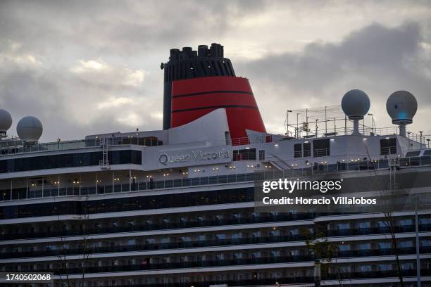 Queen Victoria, a 90,049 GT Vista-class cruise ship operated by the Cunard Line, is seen moored on a stormy morning at Lisbon cruise terminal on...